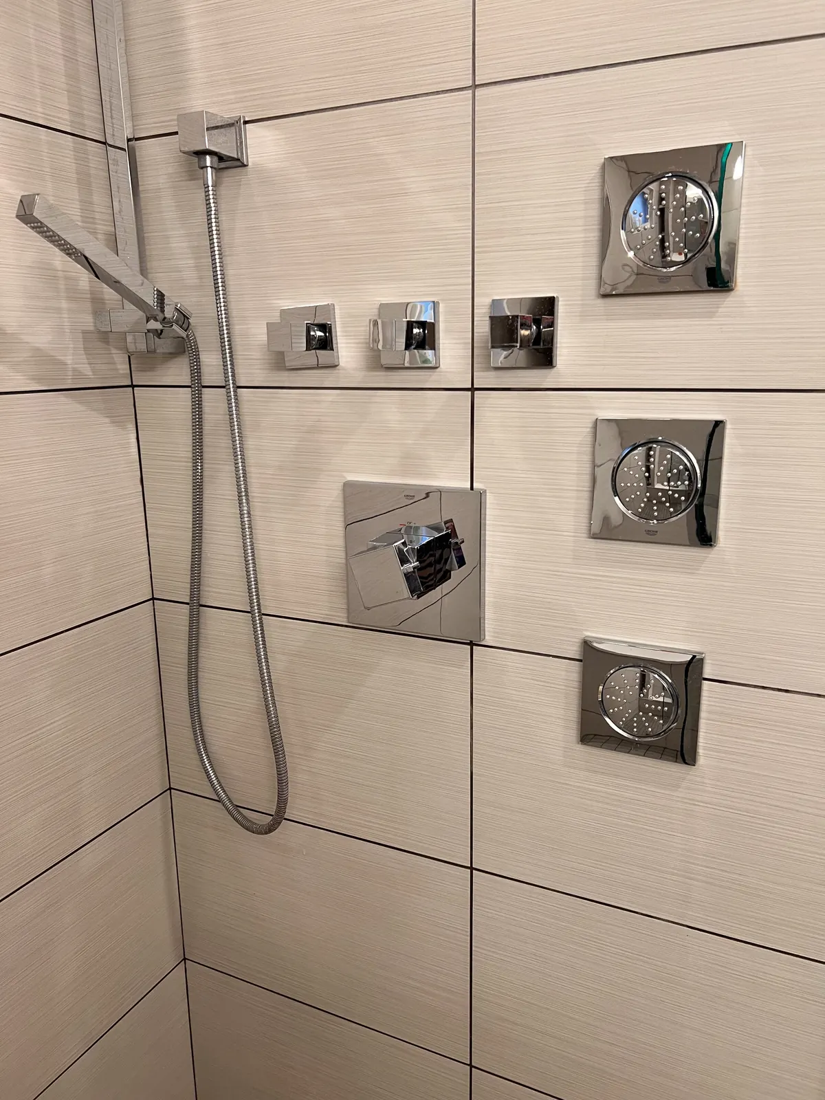Finished bathroom remodel with multi-spray shower system installed by Power Plumbing