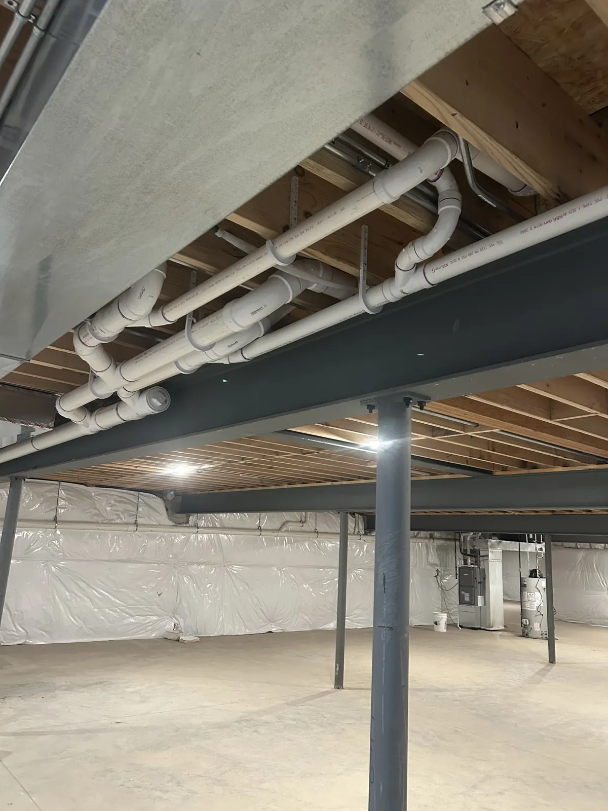 Dry, clean basement with professional plumbing installed by Power Plumbing