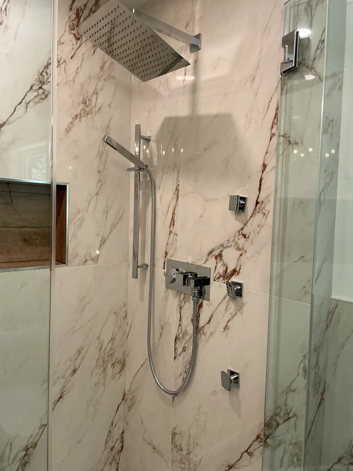 Luxury bathroom remodel with marble rain shower installed by Power Plumbing